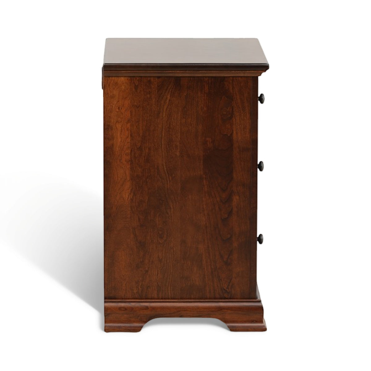 Brown wood nightstand with three drawer faces and round metal knobs, side view