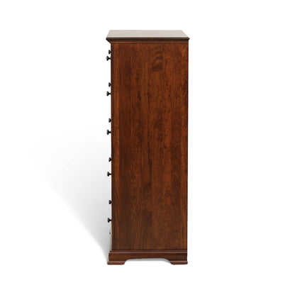 Tall wooden chest of drawers showing the side profile and drawer hardware