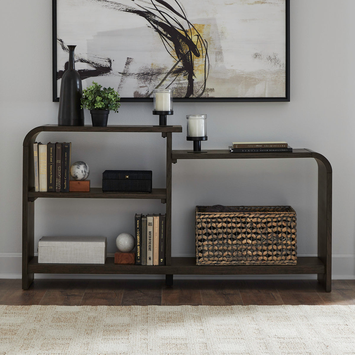 Dark wood sofa table with three-tier open shelving and rounded outer corners