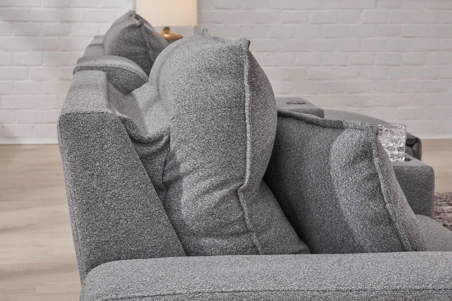 Gray recliner chaise section with thick cushions and padded armrests