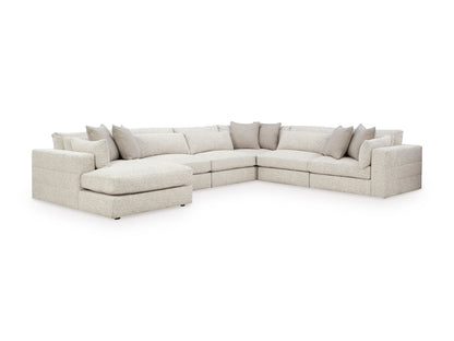 Light beige L-shaped sectional with chaise and multiple throw pillows