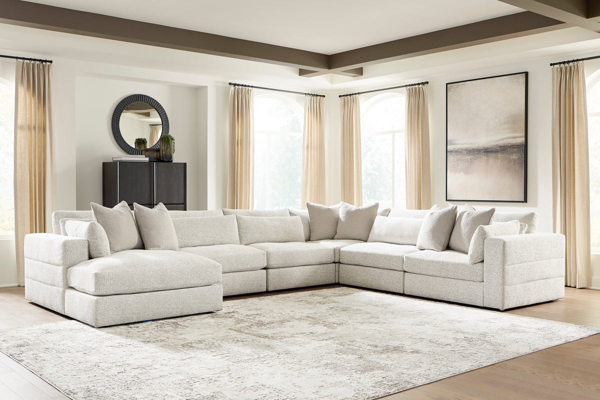 Light beige modular sectional sofa with chaise, square arms, and back cushions