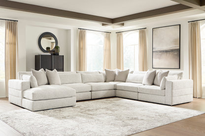 Light beige modular sectional sofa with chaise, square arms, and back cushions