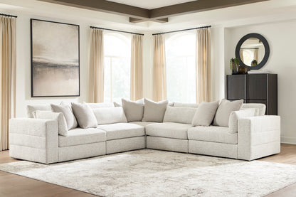 Light gray modular sectional sofa with square arms and plush seat cushions
