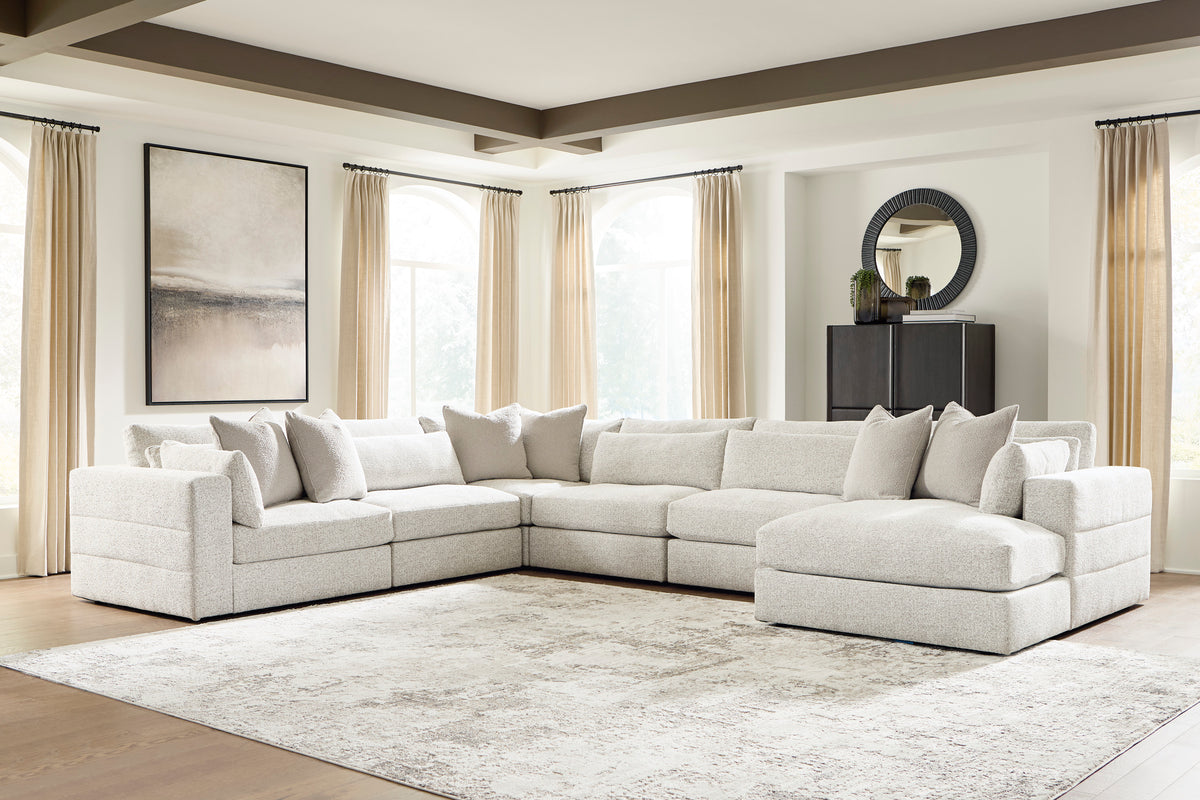 Light beige modular sectional sofa with chaise and coordinating seat and back cushions
