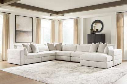 Light beige modular sectional sofa with chaise and coordinating seat and back cushions