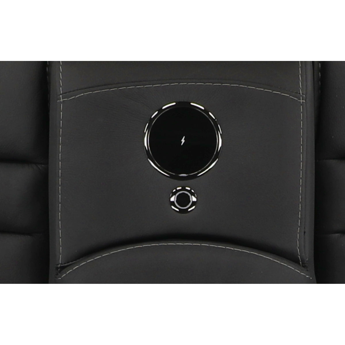 Close-up of round power console button on black leather loveseat back.