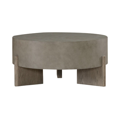 Round gray coffee table with suede-look top and four block legs