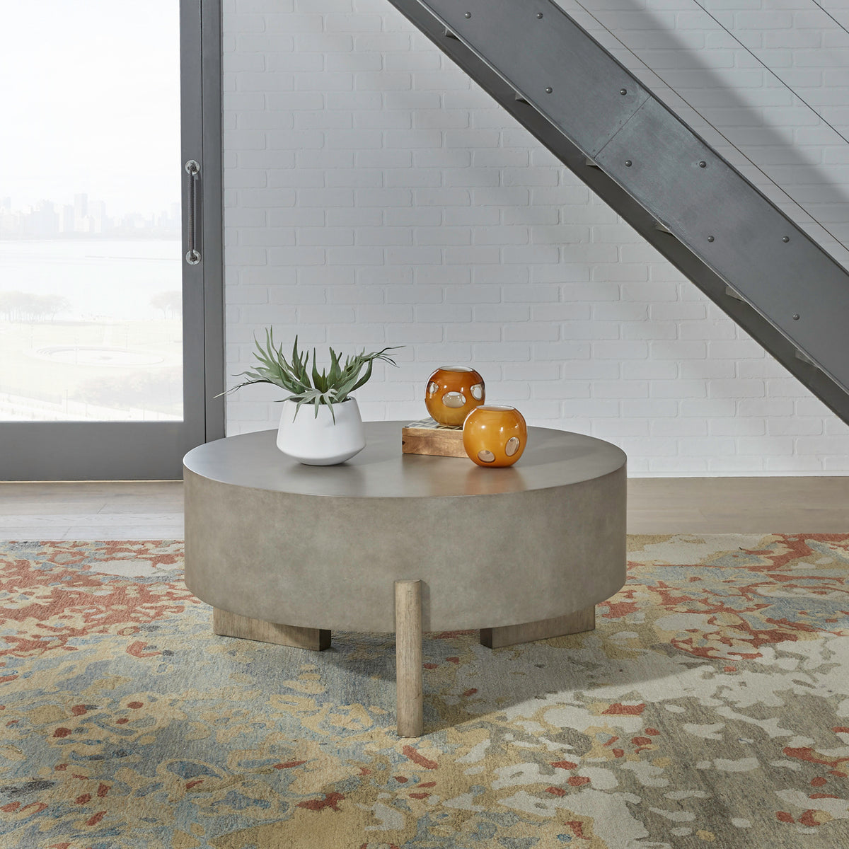 Round gray coffee table with thick tabletop and chunky wood legs