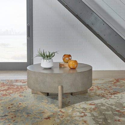 Round gray coffee table with thick tabletop and chunky wood legs