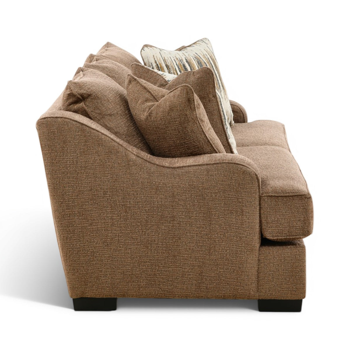 Brown fabric sofa with deep seat and multiple stacked accent pillows