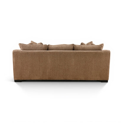 Brown fabric sofa with three seat back cushions and neatly arranged pillows