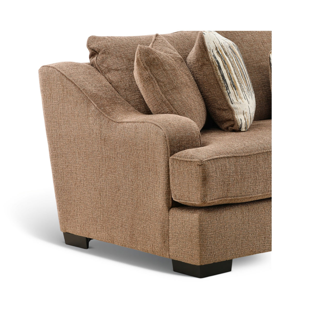 Close view of brown sofa arm and seat with striped accent pillows