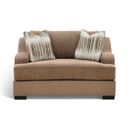 Brown upholstered chair with wide arms and two matching striped accent throw pillows