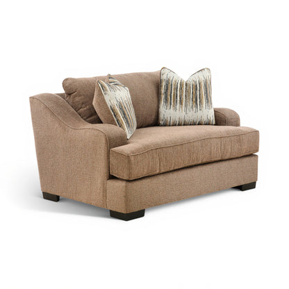 Brown accent chair with square seat, low armrests, and two striped throw pillows
