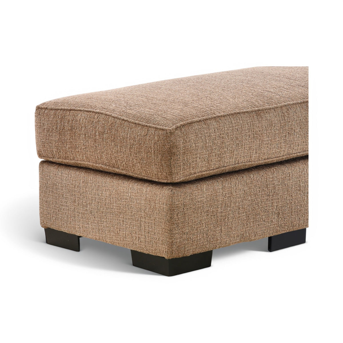 Tan upholstered ottoman with rounded corner top and black feet, angled view.