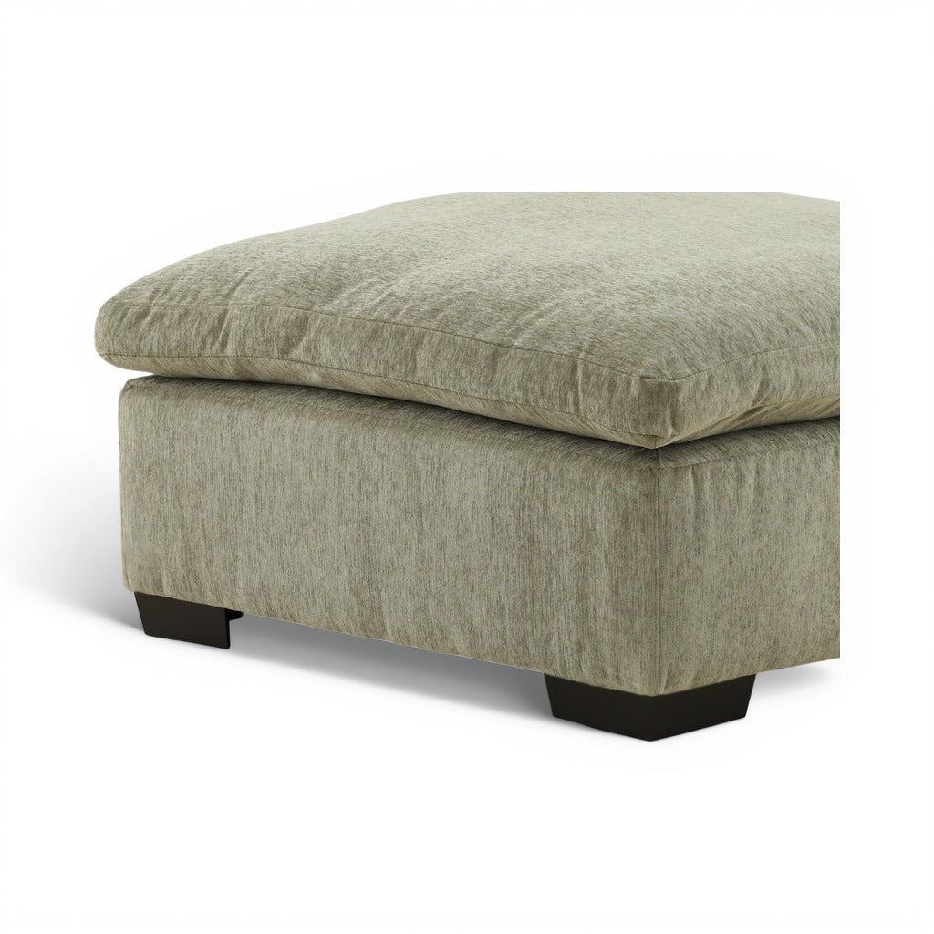 Light green ottoman with detailed top seam and black block legs