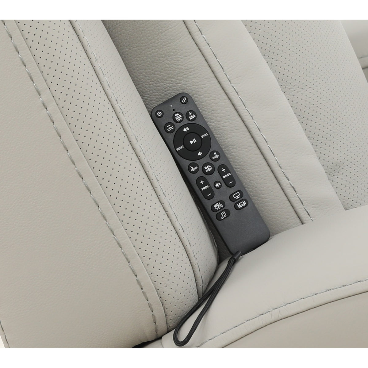 Leather power recliner remote control on light upholstery armrest