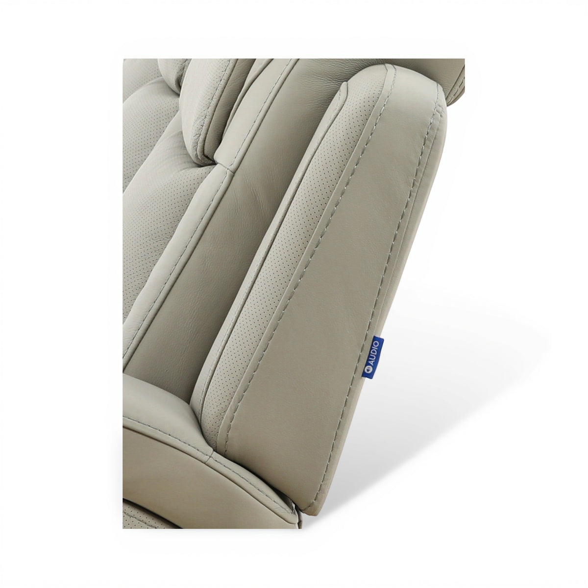 Beige leather recliner side with perforated insert and blue brand label on panel