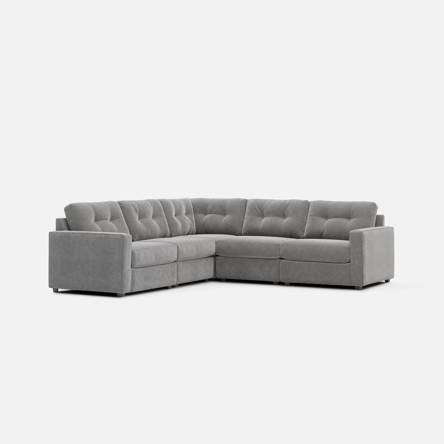 Stone gray modular sectional sofa with tufted back cushions and corner chaise