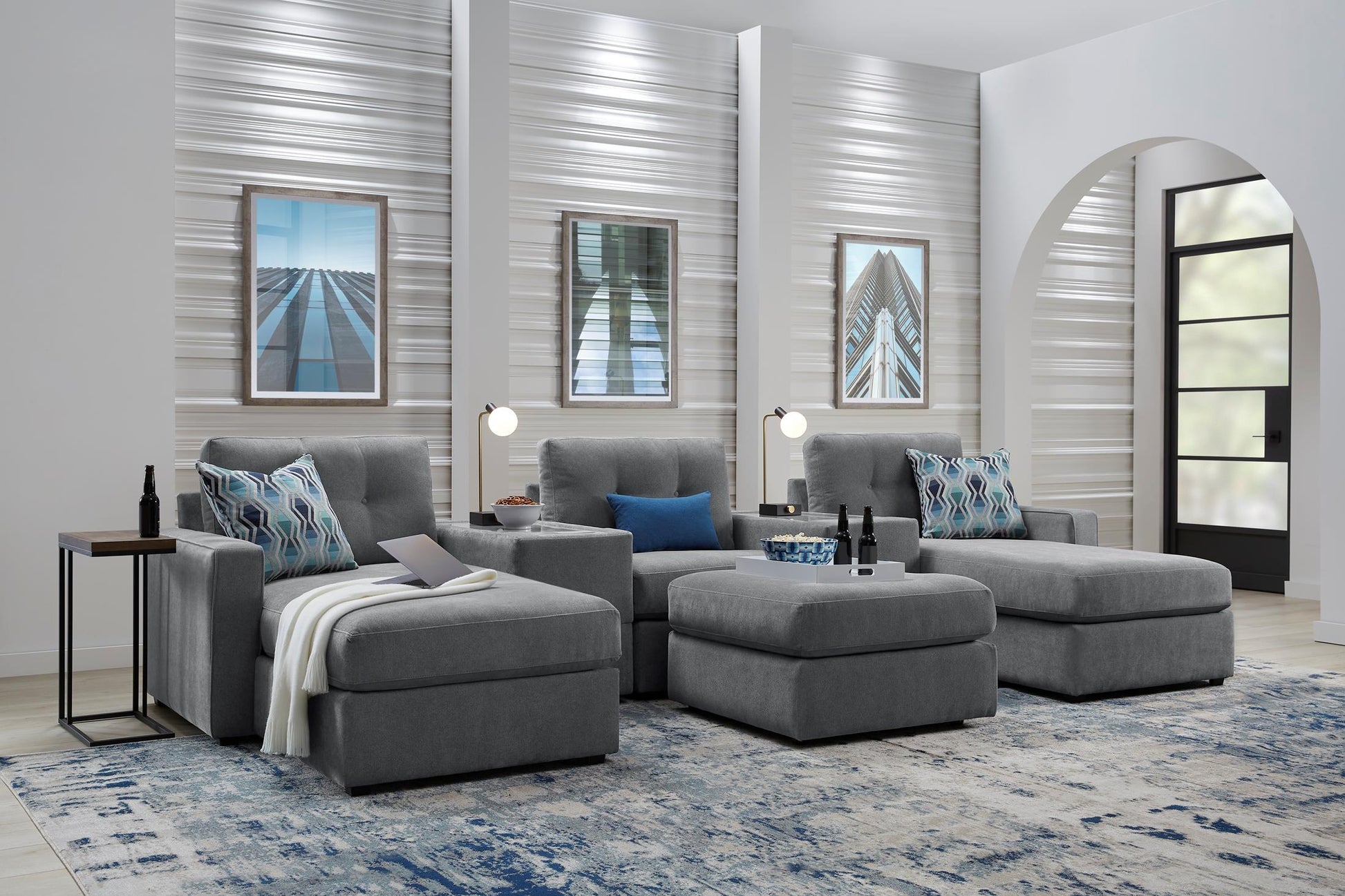 Modular theater sectional with dual chaises in light gray upholstery, staged living room view.