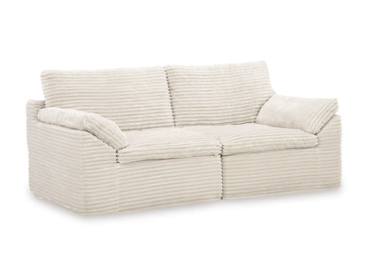 Cream striped loveseat with tufted back cushions and rolled arms