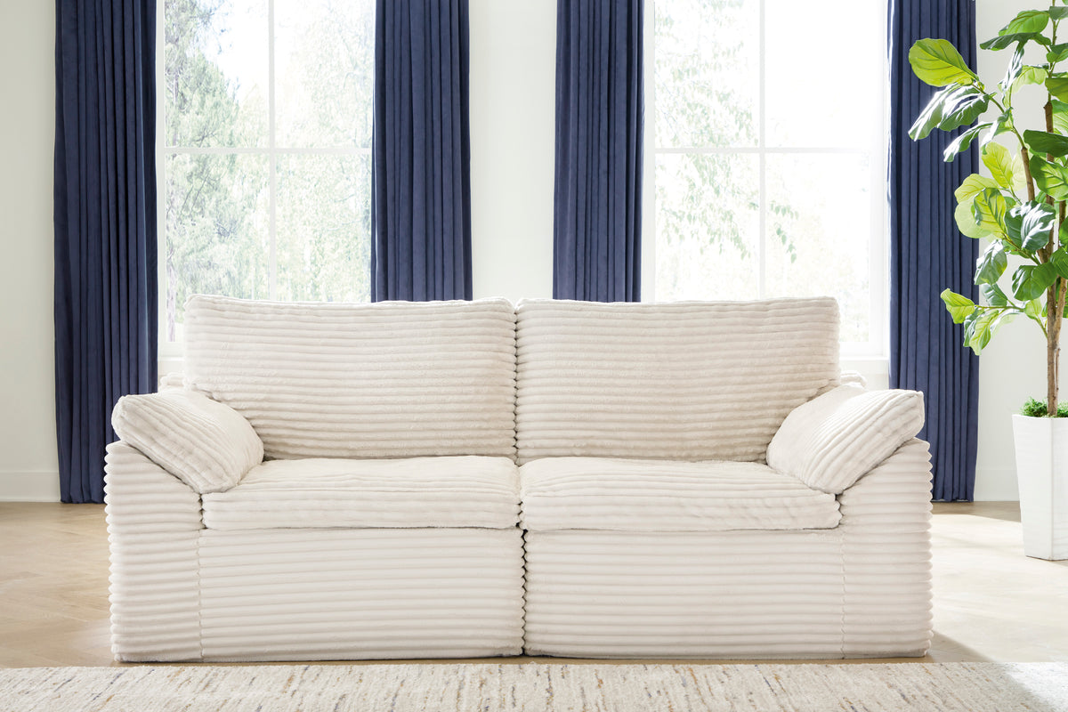 Cream striped 2-seat loveseat with rolled arms and two back cushions