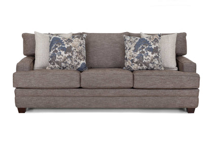 Gray fabric sofa with three seat cushions and two blue floral pillows
