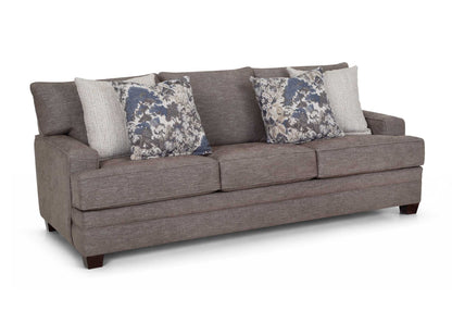 Gray fabric sofa with rolled arms and two floral throw pillows