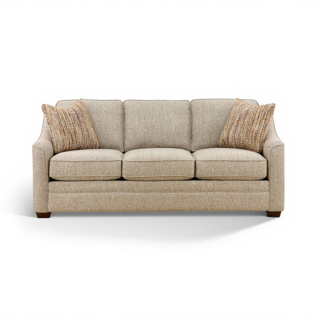 Light beige three-seat sofa with tufted back cushions and two tan striped throw pillows.