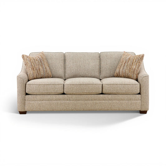 Light beige three-seat sofa with tufted back cushions and two tan striped throw pillows.
