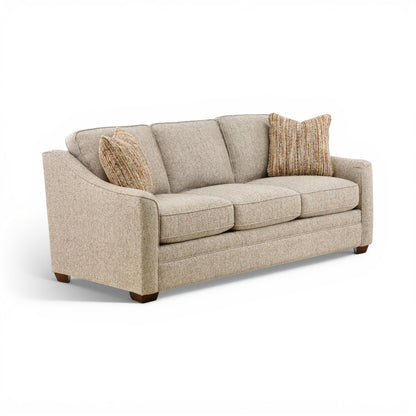 Beige fabric sofa with curved arms, three cushions, and two striped accent pillows.