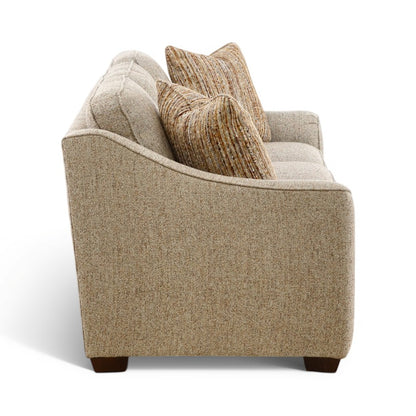 Beige accent sofa with two striped pillows, plush back, and exposed dark wood legs.
