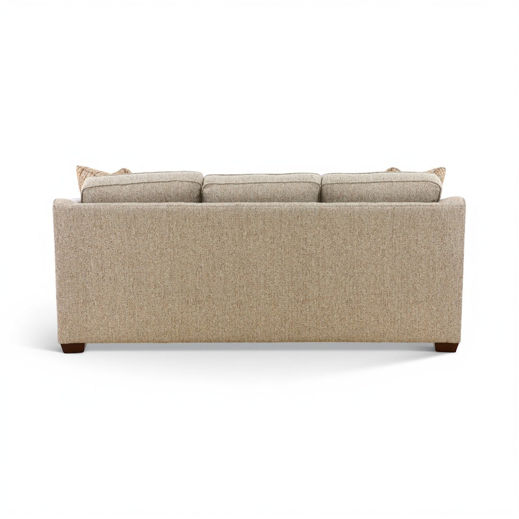 Beige upholstered sofa with straight back and rolled armrests, two included throw pillows.