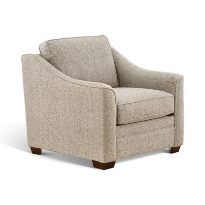 Light beige upholstered accent chair with wide arms and back, dark wood legs