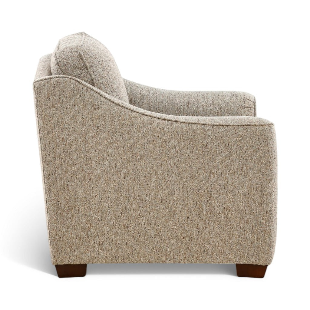Light beige upholstered chair with deep seat, curved sides, dark brown legs