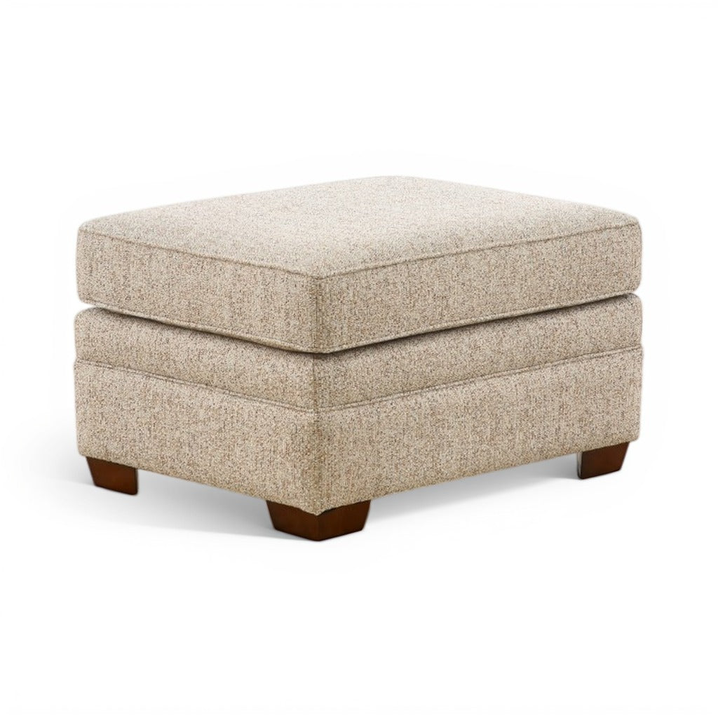 Beige upholstered ottoman with squared corners and dark wood feet