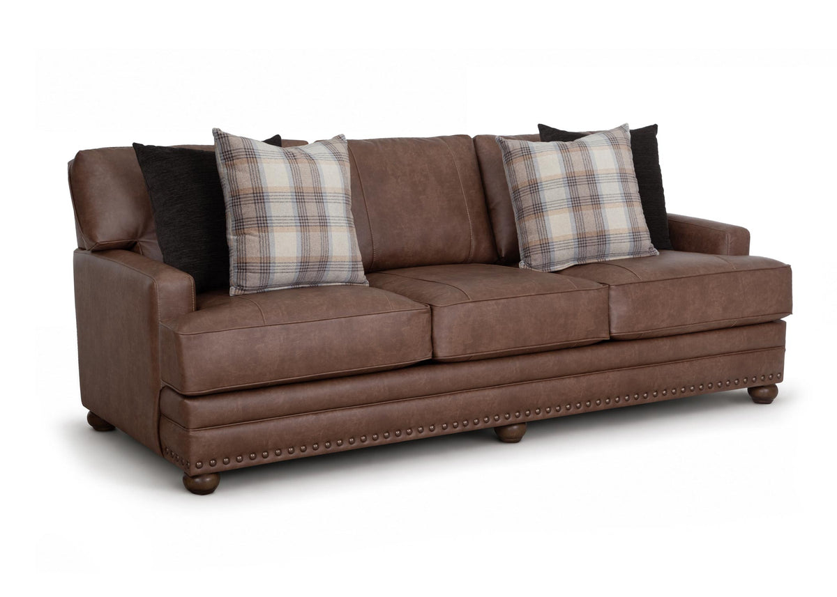 Brown Kyler sofa with three seat sections, plaid pillows, and nailhead trim on base