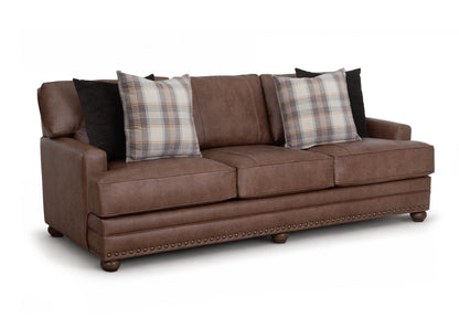 Brown Kyler sofa with three seat sections, plaid pillows, and nailhead trim on base