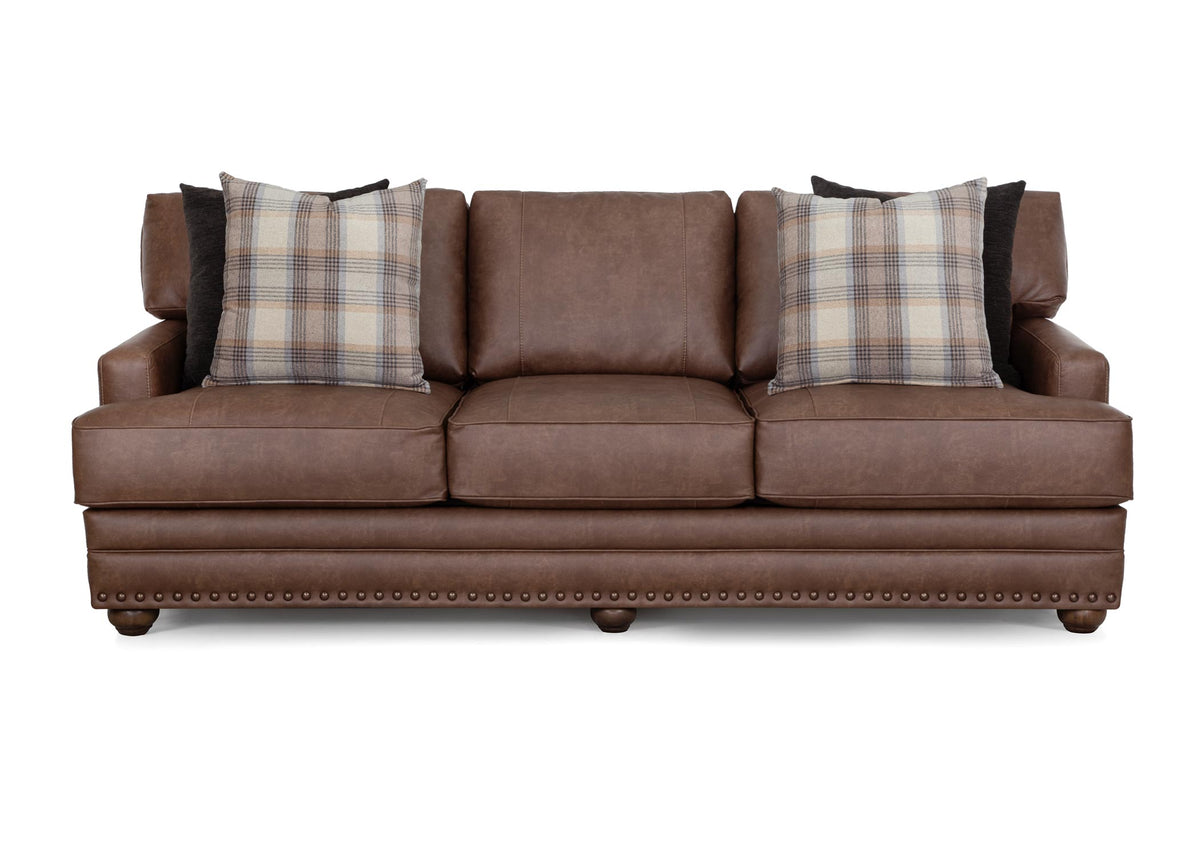 Brown Kyler sofa with three seats, plaid back pillows, and nailhead trim front