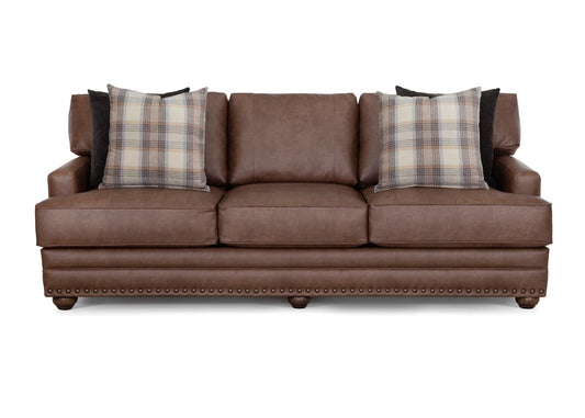 Brown Kyler sofa with three seats, plaid back pillows, and nailhead trim front