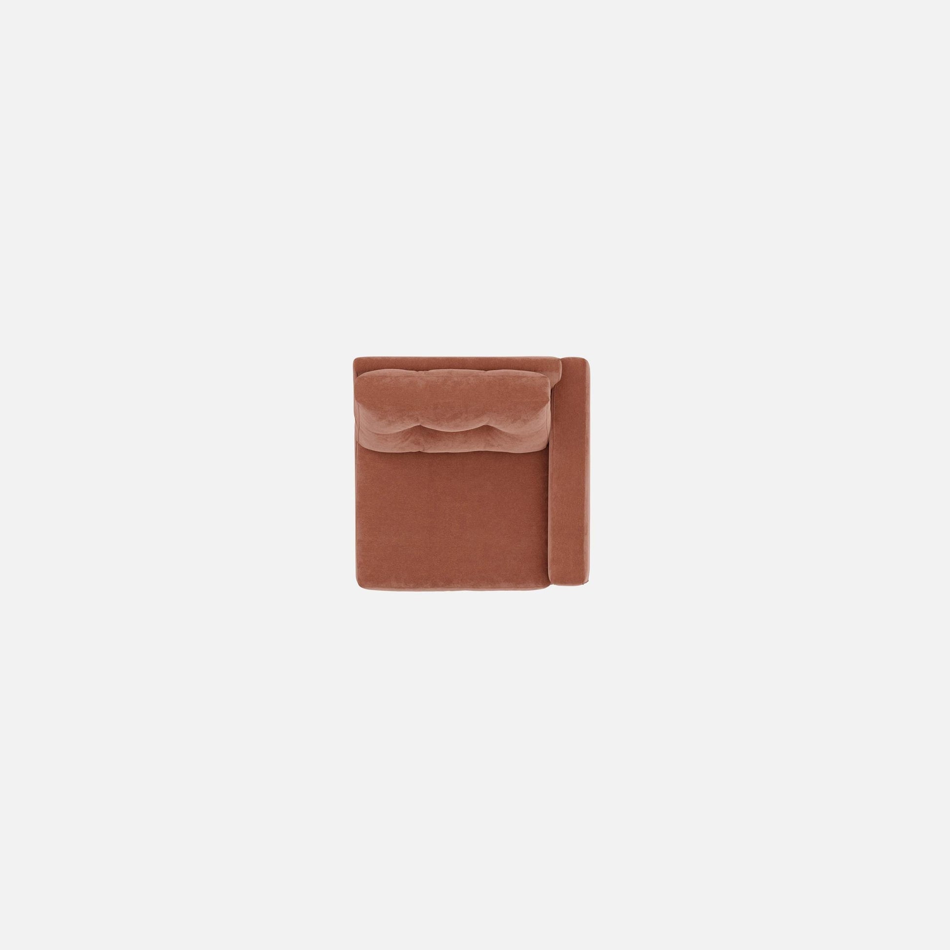 Modular chair corner view in terracotta-brown fabric with tufted back detail.