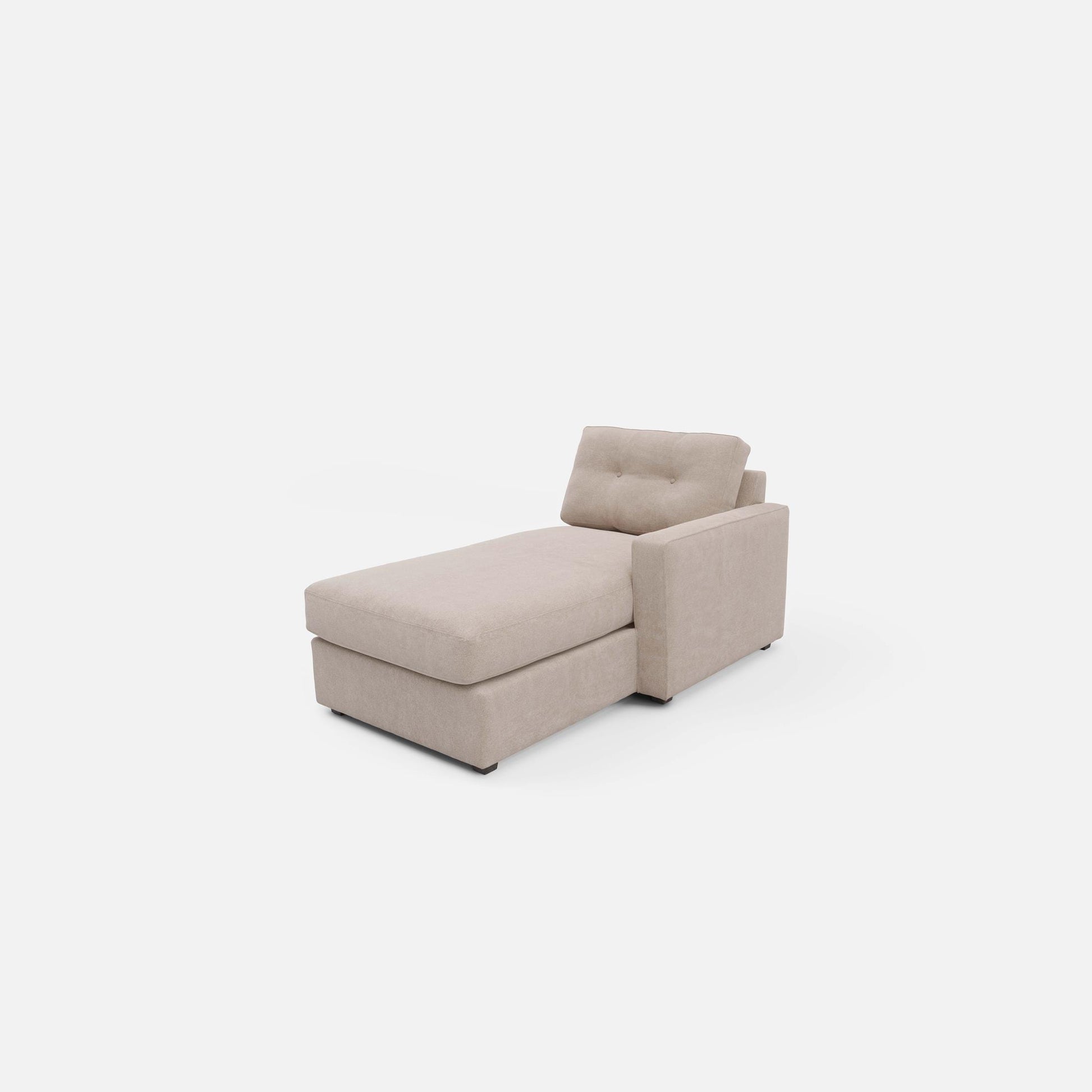 Light beige chaise lounge with tufted backrest and block arm, angled view
