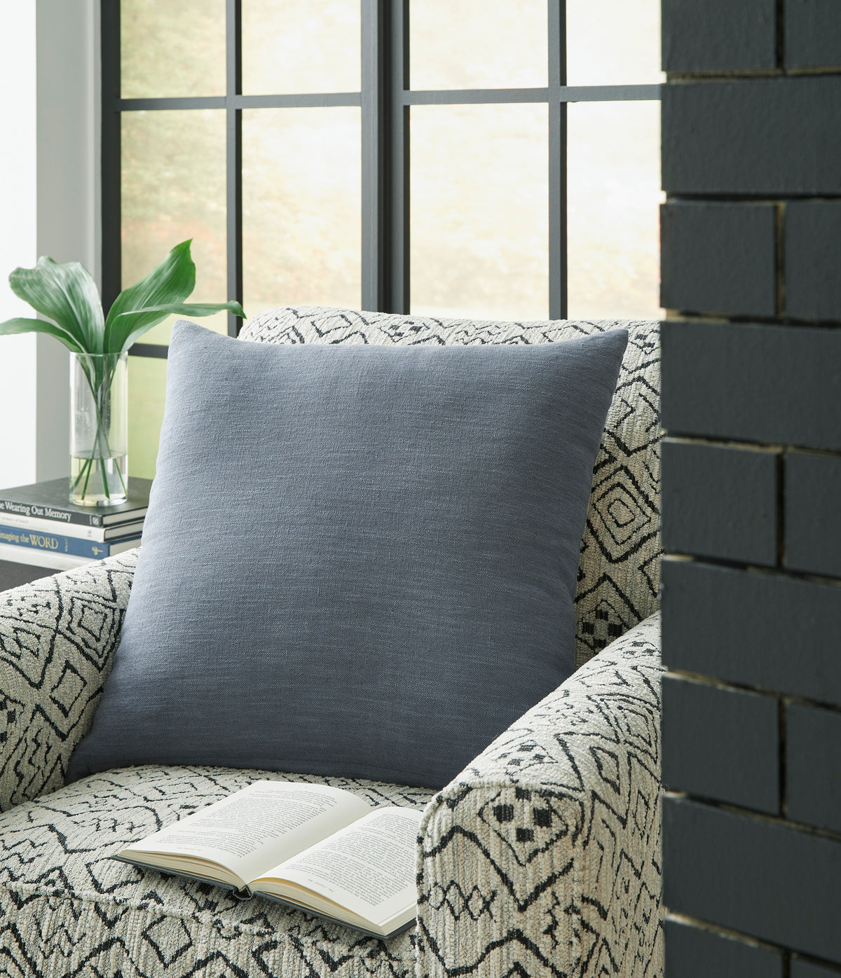 Blue square throw pillow with textured woven fabric, shown from a front angle