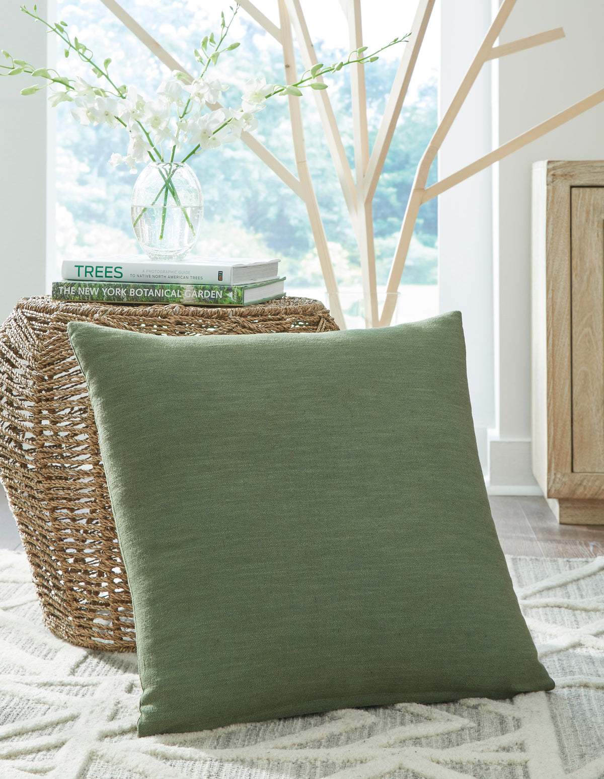 Green square throw pillow with textured woven fabric, front view