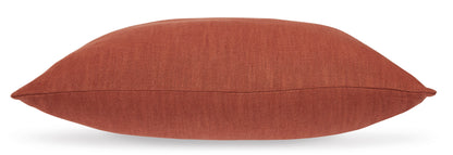 Rust fabric throw pillow with stitched edge seam
