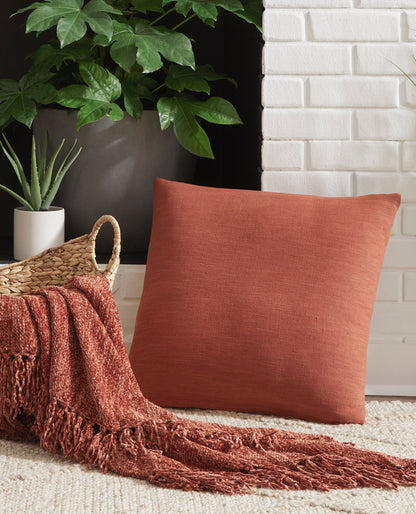 Rust square throw pillow with textured woven fabric, front view