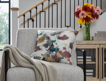 Abstract watercolor print throw pillow on a light upholstered chair