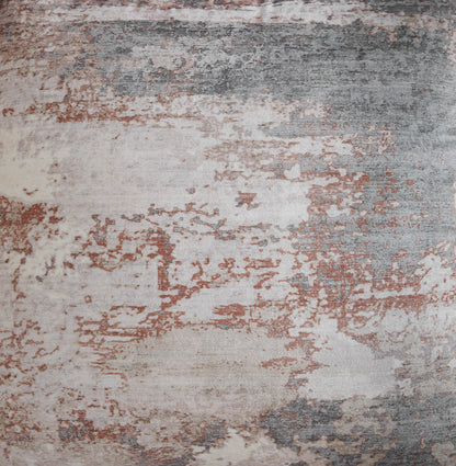 Close-up of distressed abstract pillow fabric in beige, gray, and rust
