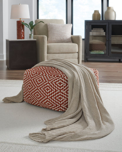 Oatmeal throw blanket with geometric red pattern and fringed edges